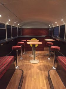 stools and tables on wooden floor static bus hire